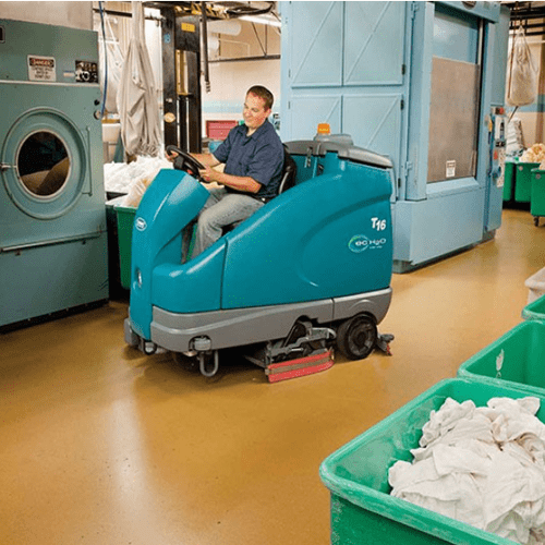 Tennant T16 Ride on Scrubber Dryer Cleaning a Workshop Floor